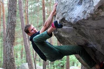 climber doing heel hook outdoors